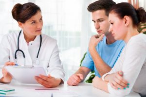 bigstock-Doctor-Consults-A-Young-Couple-35703737